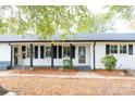 White brick front exterior with black shutters, porch, and stone walkway at 6372 Morehead Rd, Harrisburg, NC 28075