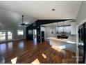 Living room flowing into the modern kitchen with marble countertops and sleek white cabinets at 914 30Th Avenue Nw Dr # 1, Hickory, NC 28601