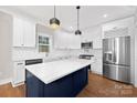 Modern kitchen with a large island, stainless steel appliances, and white cabinets at 1002 Fairground St, Charlotte, NC 28208