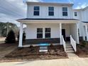 White two-story townhome with a front porch and landscaping at 105 Ciara Pl # A, Mooresville, NC 28117