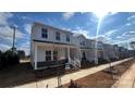 Row of new townhouses with white exteriors and landscaping at 105 Ciara Pl # A, Mooresville, NC 28117