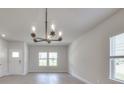 Bright dining room with chandelier and hardwood floors at 105 Ciara Pl # C, Mooresville, NC 28117