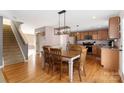 Kitchen with light brown cabinets, hardwood floors, and a wooden dining table at 160 Hedgewood Dr, Mooresville, NC 28115