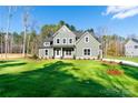 Inviting two-story home with a lush green lawn and mature trees, creating a serene setting at 1865 Rock Hill Church Rd # 3, Matthews, NC 28104