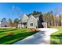 Beautiful two-story home with a well-maintained lawn and a private driveway leading to a garage at 1865 Rock Hill Church Rd # 3, Matthews, NC 28104