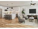 Open concept living room and kitchen featuring stainless appliances, an island, and hardwood floors at 305 Pawley Dr, Charlotte, NC 28214