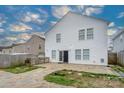 House's back features a patio, grill, and stone fireplace at 4126 Kellybrook Dr, Concord, NC 28025