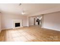 Open living room with hardwood floors and a fireplace at 8724 Old Plank Rd, Charlotte, NC 28216