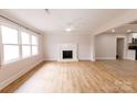 Living room boasts hardwood floors and a fireplace at 8724 Old Plank Rd, Charlotte, NC 28216