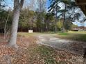 Large backyard with mature trees and gravel area at 925 Rock Grove Church Rd, Salisbury, NC 28146