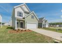 A charming two-story home with a two-car garage, front yard, and a well-manicured lawn at 1150 Red River Dr, Salisbury, NC 28144