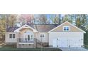 Two-story house with a three-car garage and large windows at 13000 John Bostar Ln, Charlotte, NC 28215