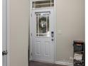 Front entry door with glass panel and wreath, hardwood floor at 18014 Pear Hawthorne Dr, Huntersville, NC 28078