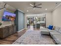 Open living room with gray sectional sofa and view into kitchen at 18014 Pear Hawthorne Dr, Huntersville, NC 28078