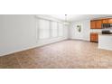 Bright dining area featuring tile flooring, a modern light fixture, and a window view at 2318 Sweet Flag Ct, Charlotte, NC 28262
