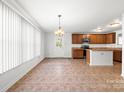 An open kitchen with wood cabinets and stainless steel appliances leads into a spacious dining area at 2318 Sweet Flag Ct, Charlotte, NC 28262