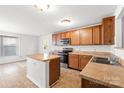 Traditional kitchen with wood cabinets, stainless steel appliances and an island at 2318 Sweet Flag Ct, Charlotte, NC 28262