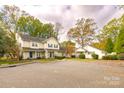 Townhome exterior showcasing manicured lawns, matching doors, and mature landscaping at 2702 New Hamlin Way, Charlotte, NC 28210