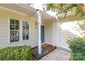Inviting front entrance with covered porch, blue door, and decorative columns at 2702 New Hamlin Way, Charlotte, NC 28210