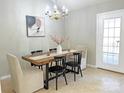 Charming dining area with a rustic wooden table and chandelier at 452 Peaceful Creek Dr, York, SC 29745