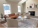 Bright living room featuring a fireplace and large windows at 452 Peaceful Creek Dr, York, SC 29745