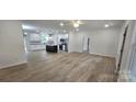 Open-concept living space with a kitchen island and wood-look flooring at 536 Robinhood Rd # 27, Maiden, NC 28650