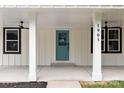 Quaint front porch with ceiling fans and a teal front door at 1905 Umstead St, Charlotte, NC 28205