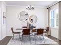 Elegant dining room with stylish decor, contemporary lighting, and a large window at 5676 Clear Creek Ln, Charlotte, NC 28215