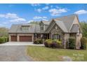 Charming stone and brick home with a three-car garage and well-maintained landscaping at 3678 Rankin Rd, Concord, NC 28027