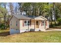 Quaint home with tan siding, white trim, and a welcoming front porch at 108 W Maryland Ave, Bessemer City, NC 28016
