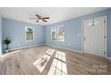 Open-concept living room featuring a ceiling fan, recessed lighting, and gleaming wood floors at 108 W Maryland Ave, Bessemer City, NC 28016