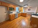 Kitchen with wood cabinets, stainless steel dishwasher, hardwood floors, and breakfast area at 115 Turner St, Lincolnton, NC 28092