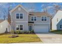 Charming two-story home features a two-car garage, manicured lawn, and a welcoming light blue front door at 2507 Andes Dr, Statesville, NC 28625