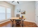 Bright office space with wood floors, a ceiling fan, and a large window providing ample natural light at 3848 Zemosa Nw Ln, Concord, NC 28027