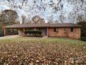 Brick ranch home with attached carport and landscaped yard at 912 Surry Dr, Shelby, NC 28152