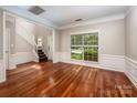 Living Room with hardwood floors, wainscotting, and stairs at 107 Monterey Dr, Mooresville, NC 28117