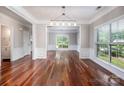 Open-concept living room with wainscotting, and hardwood floors at 107 Monterey Dr, Mooresville, NC 28117
