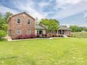 Beautiful brick house with a lush green lawn and vibrant landscaping, offering a welcoming curb appeal at 3092 Lee Lawing Rd, Lincolnton, NC 28092