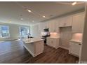 Modern kitchen featuring a center island, stainless steel appliances, and white cabinets at 6259 Tea Olive Dr # 178, Harrisburg, NC 28075