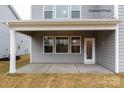 Covered patio with gray flooring and white trim, adjacent to the house at 1029 Wandsworth Pl # Ken0105, Charlotte, NC 28215