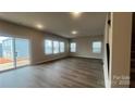 Spacious Gathering room with hardwood floors and sliding glass doors at 106 Obadiah Ct, Troutman, NC 28115