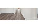 A bright hallway showcases new flooring leading towards bright rooms at 118 Satchel Ct, Troutman, NC 28115