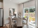 Elegant dining room with a round table, cushioned chairs, and sliding glass door to the backyard at 122 Satchel Ct, Troutman, NC 28115