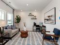 Modern living room with neutral tones, stylish decor, a patterned rug and plenty of natural light at 122 Satchel Ct, Troutman, NC 28115