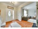 Inviting foyer with hardwood floors, decorative door with sidelight, and views into the adjacent living room at 3195 Hadden Hall Blvd, Fort Mill, SC 29715