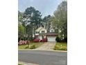 Inviting two-story home with attached garage, well-maintained lawn, and colorful azalea bushes at 3195 Hadden Hall Blvd, Fort Mill, SC 29715