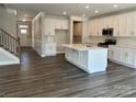 Modern kitchen with white cabinets, stainless steel appliances, and large center island at 5112 Heathland Dr # 75, Charlotte, NC 28215