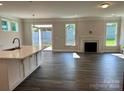 Bright living room with fireplace, wood floors, and sliding door access to the backyard at 5112 Heathland Dr # 75, Charlotte, NC 28215