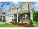 Charming two-story home featuring stone accents, a well-manicured lawn, and a two-car garage at 5115 Heathland Dr # 47, Charlotte, NC 28215