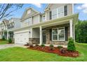 Charming two-story home featuring stone accents, a well-manicured lawn, and a two-car garage at 5115 Heathland Dr # 47, Charlotte, NC 28215